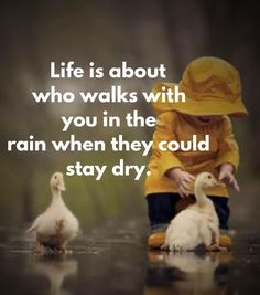 a little boy sitting on top of a puddle next to two ducks and the words life is about who walks with you in the rain when they could stay dry