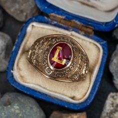 This vintage 1959 Lyons High School class ring is centered with a bezel set red glass cabochon with the letter "L" in the center. The ring is crafted of 10k yellow gold that has a great patina to it. Vintage Engraved Round Ring Collectible, Vintage Engraved Ring For Commemoration, Classic Red Signet Ring Stamped 14k, Vintage Oval Initial Ring, Vintage Oval Engraved Ring With Initials, Classic Ruby Ring With Polished Finish For Collectors, Heirloom Ruby Ring With Polished Finish, Heirloom Collectible 14k Stamped Ruby Ring, 14k Gold Engraved Ring With Initials For Collectors