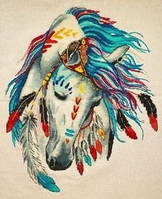 a white horse with blue hair and feathers on it's head is depicted in this embroidery design