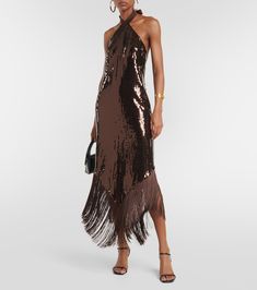 a woman wearing a brown sequin dress with fringes on the skirt and heels