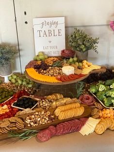 a table filled with lots of different types of food on top of eachother