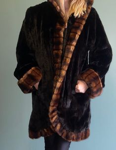 Pamela McCoy Faux Fur Hooded Coat / 90s Y2k Black Fur Coat / Penny Lane Coat / Faux Mink Jacket Black & Brown Fur Coat Pamela McCoy Tags size small  Pamela McCoy /Tissavel France tags 100% acrylic Black satin lining Hooks and clasps up the front 2 pockets Excellent Condition, no areas of stain or damage Measurements lying flat: Length:34" Shoulder:17" Bust:20" Waist:22" hips:23" Sleeve length:23" Sleeve opening:9" Model is 34c 27 waist 37 hips 5'5" Brown Fur Coat With Faux Fur Lining, Vintage Faux Fur Coat For Cold Weather, Cozy Brown Long Sleeve Fur Coat, Vintage Faux Fur Outerwear With Long Sleeves, Vintage Faux Fur Long Sleeve Outerwear, Vintage Long Sleeve Faux Fur Outerwear, Brown Faux Fur Coat For Cold Weather, Oversized Brown Fur Coat With Long Sleeves, Vintage Hooded Fur Coat For Fall