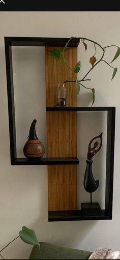 two shelves with vases and other decorative items on them