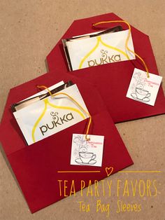 two red envelopes with tea party favors on them