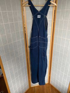 "1970's blue denim Lee's bib overalls Size XS waist: 25\" hips: 34\" inseam: 30\"" Denim Bib Front Overalls, Retro Dark Wash Denim Jumpsuit, Retro Denim Bib Front Jumpsuit, Retro Denim Jumpsuit With Bib Front, Blue Utility Overalls With Straight Leg, Blue Utility Straight Leg Overalls, Retro Denim Blue Overalls With Pockets, Blue Straight Leg Utility Overalls, Retro Blue Denim Jumpsuit With Pockets