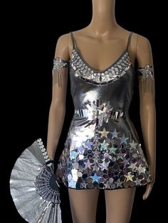 Mirror rhinestone rave festival skater dress.  Silver metallic with acrylic mirrors and sequins.   Umbrella, hand fan, feather mirrored boot wraps and star arm wraps.  Choose the full outfit or separate pieces.  Disco Rave festival outfit.  Made of high quality spandex fabric , acrylic mirrors and rhinestones.  Reflects when light hits it. Great for raves, music festivals, night clubs, social media and pictures. Star Festival Outfit, Stars Outfit Aesthetic, Disco Rave Outfit, Silver Concert Outfit, Space Rave Outfit, Space Theme Outfit, Galactic Party Outfit, Star Outfit Aesthetic, Metallic Silver Outfit