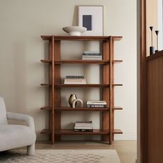 a living room with a chair and bookshelf