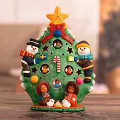 a small christmas tree with people around it