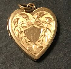 "A retro 14kt yellow gold hand engraved sweet diminutive locket.  Condition very good for its age I see no problems-hinge works, snaps close-has top gold ring for chain, wt. 1.6 grams.  NO MONOGRAM!  size approx 7/8\" including ring.  Marked inside 14kt with makers mark-HFB." Vintage 14k Gold Locket Necklace Stamped 14k, Vintage 14k Gold Locket Necklace, Victorian Jewelry In 14k Gold With Hallmark, Victorian 14k Gold Jewelry With Hallmark, Heirloom Yellow Gold Locket Necklace With Charms, Antique Keepsake Locket Necklace With Hallmark, Vintage 14k Gold Locket Jewelry, Antique Gold Locket Necklace With Charms, Gold Antique Locket Necklace With Charms