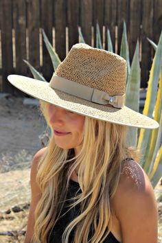 Our Palm Desert Panama fit in perfectly on our latest road trip photo shoot. Stunning, classic, chic - everything you've ever wanted in a hat. Featuring a molded crown with a pinched 10cm brim and hand woven straw, it's crystallized on the tone on tone ribbon with a simple Swarovski rivet. -Rancher style hat with a chill & casual vibe-Brim is flexible but holds its shape-Coordinating ribbon band-Pinched top-Great quality-- will last forever-This color actually goes with everything effortless Classic Woven Straw Hat, Woven Straw Hat With Structured Crown, Woven Straw Hats With Structured Crown, Beach Boater Hat With Structured Crown, Adjustable Toquilla Straw Sun Hat With Structured Crown, Adjustable Straw Sun Hat With Structured Crown, Elegant Braided Straw Hat For Summer, Elegant Braided Brimmed Sun Hat, Elegant Braided Hats For Spring