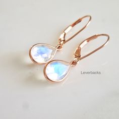 "Beautiful 8 x 6 mm oval moonstones bezel set in sterling silver or solid 14 karat yellow gold. The simplicity with amazing moonstones makes these spectacular. Stunning blue color, especially in the sun and just gorgeous to wear. natural moonstones faceted 8 x 6 oval clear with a beautiful blue light eye-visible inclusions, naturally occurring Drop length 3/4 Inch Can be set in 14k yellow gold bezel with Hooks or Lever Backs OR/ Sterling Silver With Hook ear wire Made to Order - 1 week productio Modern Hypoallergenic Oval Jewelry, Minimalist Nickel Free Moonstone Earrings, Minimalist Nickel-free Moonstone Earrings, Minimalist Nickel Free Moonstone Jewelry, Minimalist Nickel-free Moonstone Jewelry, Hypoallergenic Gold Moonstone Jewelry, Adjustable Teardrop Moonstone Jewelry, Everyday Teardrop Jewelry With Bezel Setting, Everyday Nickel Free Moonstone Jewelry