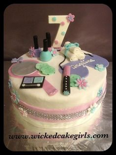 a birthday cake with the number one on it's top and various items around it