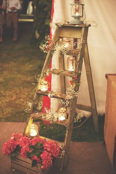 a ladder decorated with candles and flowers