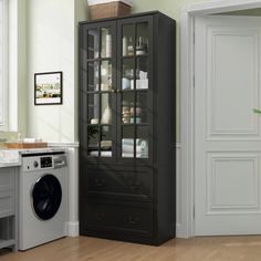 a washer and dryer in a room next to a cabinet with glass doors