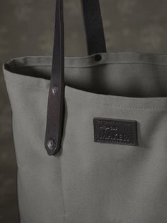 The ultimate carry-all, this sturdy cotton canvas tote with thick leather straps and inside pocket, is functional and durable. The extra-long handles make it super comfortable to carry over shoulders, and fits our everyday essentials, including a laptop.  What we love about it We first discovered Detroit Denim when we Canvas Bag With Reinforced Double Handles, Everyday Coated Canvas Bag With Reinforced Handles, Coated Canvas Bag With Reinforced Handles For Everyday Use, Canvas Tote Shoulder Bag With Reinforced Handles, Waxed Canvas Bag With Leather Handles For On-the-go, Duck Canvas Bag With Reinforced Handles For Daily Use, Everyday Canvas Bag With Duck Canvas Lining, Double Handle Cotton Canvas Bag For Travel, Rectangular Canvas Weekender Bag With Leather Handles