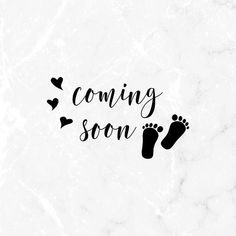 the words coming soon are written in black ink on a white marble background with hearts