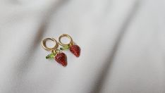 Strawberry earrings for any occassion. These are super cute and small for those that love the minimalist look. The strawberry charm is made out of alloy and measures 1cm. The earring from top to bottom measures 1.25 inches.  Each pair is handmade and sterlized before shipped. Sweet Handmade Earrings As Gift, Sweet Handmade Earrings For Gift, Trendy Berry Colored Jewelry For Gifts, Trendy Tiny Adjustable Earrings, Sweet Nickel-free Jewelry Gift, Sweet Drop Earrings Jewelry Gift, Sweet Drop Earrings As A Gift, Handmade Trendy Hoop Earrings For Gift, Handmade Delicate Hoop Earrings As Gift