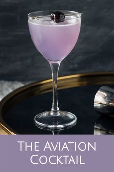 the aviation cocktail is served in a coupe glass with an olive garnish on top