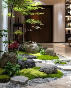 an indoor garden with rocks and grass