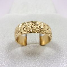 Jahda Jewelry Company Phone Support (text message or voice calls): 916-533-6907 MADE IN THE USA * LAYAWAY PAYMENT PLANS AVAILABLE Item Details Inspired by royal Hawaiian jewelry styles, this ring design was originally hand-carved and created using traditional jewelry making techniques. Item: Solid 14K Yellow Gold Hand Engraved Hawaiian Scroll Band Ring Material: 14K Yellow Gold Size: Ring sizes 3 through 12 are available - Band is 6mm Wide (Note: Wider bands tend to fit a quarter to half size sm Hawaiian Jewelry, Fancy Rings, Bold Jewelry, Jewelry Styles, Ring Hand, Gold Hand, Gold Hands, Traditional Jewelry, Jewelry Companies