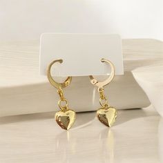 Elevate your style with these exquisite hypoallergenic gold plated handmade heart hoop earrings. Meticulously crafted for those with sensitive skin, these earrings offer a perfect blend of elegance and comfort. The heart-shaped design adds a touch of romance and sophistication to any outfit, making them a versatile accessory for both casual and formal occasions. ●14.5mm 24k gold plated lever back hoop earring ●10mm 18k gold plated heart charm 💎Hypoallergenic Material: Ideal for sensitive ears, Minimalist Gold Heart Earrings With Charm, Gold Plated Hoop Earrings For Everyday And Valentine's Day, Valentine's Day Tarnish Resistant Dangle Hoop Earrings, Valentine's Day Dangle Hoop Earrings Tarnish Resistant, Valentine's Day Tarnish-resistant Dangle Hoop Earrings, Small Hoop Tarnish Resistant Earrings For Valentine's Day, Minimalist Dangle Hoop Earrings For Valentine's Day, Gold Metal Earrings With Heart Charm, Minimalist Gold Hoop Heart Earrings