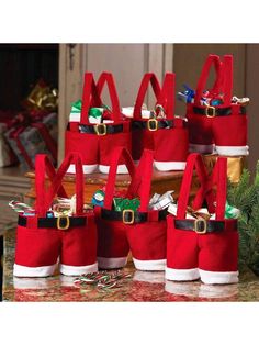 several red and white christmas bags sitting on top of a table