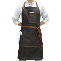 a man is wearing an apron and has his hands on his hips