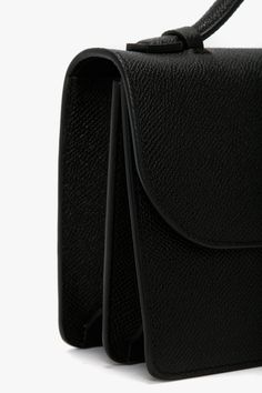 With its clean lines and slender silhouette, the Dorian Bag appeals to a multi-generational customer and is a hero item in the house’s leather goods edit. Crafted from tactile grained leather and designed in classic Black, it features the brand’s signature B buckle, which has been reworked to create a dynamic new locking system, and benefits from a removable and adjustable ‘smart strap’ and snap buttons for versatile styling as a shoulder or crossbody bag. Lined in microsuede, it has an internal Luxury Grained Texture Shoulder Bag For Business, Luxury Black Bags With Grained Texture, Designer Bags With Grained Texture For Everyday Use, Luxury Grained Texture Shoulder Bag For Evening, Black Textured Leather Structured Shoulder Bag, Luxury Evening Shoulder Bag With Grained Texture, Black Structured Textured Leather Shoulder Bag, Black Evening Bags With Grained Texture, Structured Black Textured Leather Shoulder Bag