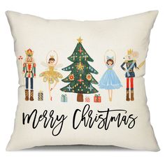 a white pillow with an image of christmas trees and nutcrackers