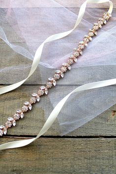 "Lovely, dainty thin floral rhinestone bridal sash. It is made up of the highest quality rhinestones prong set in rose gold finish metal backing with a ton of gleaming sparkles. Ribbon of your choice is sewn at each end of jewel part and ties at the back into a bow. Or, rhinestone jewel part can be sewn onto the dress directly without using long ribbon sash tie. A perfect complimenting piece to your wedding dress, bridesmaids dresses or any special occasion dresses. This listing is for Rose gold Indian Bridal Veil, Jeweled Wedding Dress, Disney Wedding Dresses, Bridal Roses, Flower Belt, Wedding Dress Sash, Rustic Wedding Dresses, Rose Gold Bridal, Dress Sash