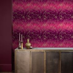 a room with purple wallpaper and gold cabinet in front of the door is a sideboard