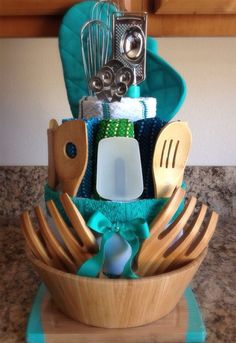 a wooden bowl filled with kitchen utensils on top of a counter