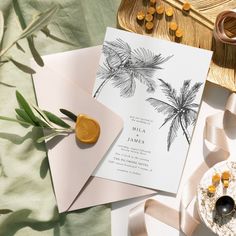 wedding stationery with palm trees on the front and back, along with other items