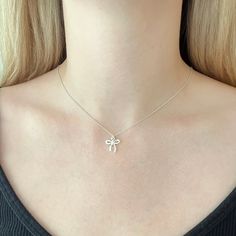 This sweet necklace features a small bow charm that boasts a beautiful bright and shiny polish.  The bow is made of sterling silver and it measures 13mm wide and about 11mm long (not including the loop). The bow slides freely along sterling silver cable chain for a simple minimalist design that can easily transition from casual to dressy. The necklace would be ideal for every day wear and would add a nice whimsical accent to an outfit. Ribbons and bows are popular right now so this accessory is Silver Ribbon Necklace For Gift, Silver Jewelry With Decorative Bow As Gift, Feminine Ribbon Necklace As Gift, Delicate Ribbon Necklace For Gifts, Delicate Ribbon Necklace For Gift, Delicate Ribbon Necklace Gift, Feminine Ribbon Necklace For Gift, White Ribbon Necklace For Gift, Dainty Ribbon Jewelry For Gifts