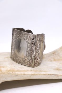 Beautiful vintage three panel silver bracelet. The panel are hand engraved on the surface.   large central panel size : 2 1/2 in x 2 1/4 in Length: 7.5 in roughly Weight: 75 grams Minor scratching on the surface .In overall good condition. Victorian Etched Cuff Bracelet, Victorian Style Silver Engraved Bangle, Victorian Silver Engraved Bangle, Victorian Style Engraved Silver Bangle, Engraved Antique Silver Cuff Bracelet For Weddings, Silver Stamped Cuff Bracelet For Wedding, Victorian Adjustable Engraved Cuff Bracelet, Antique Engraved Cuff Bangle Bracelet, Victorian Engraved Cuff Bracelet For Ceremonial Occasion