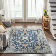 a living room filled with furniture and a blue rug