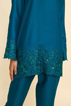 This elegant V-neck embroidered co-ord Set comes handcrafted in a loose-fitting cotton silk fabric laden with embroidery on ghera and sleeves along with embroidered palazzos. Organza stole adds to it elegance. Embroidered Co Ord Sets, Blue Silk Palazzo Set With Intricate Embroidery, Intricate Embroidery Palazzo Set In Raw Silk, Blue Pant Set With Resham Embroidery, Silk Pant Set With Floral Embroidery, Bollywood Style Floral Embroidered Pant Set For Eid, Silk Pant Set With Floral Embroidery And Straight Kurta, Traditional Pant Set With Floral Embroidery For Eid, Bollywood Style Floral Embroidery Pant Set For Eid