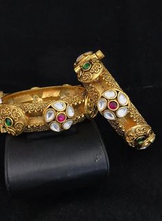 Simply a mark of royalty and elegance!! Handcrafted in brass with gold plating and fine quality Kundan stones. Set of 2 For wrist Size 2.4 Inner Diameter: 2.25 inches Easily Openable with a screw The bangles are the same as shown in the pictures. We have only one piece in this color and design, hence you get what you see in the pictures. Gold Meenakari Bangle For Marriage, Formal Brass Bangle With Intricate Design, Heavy Gold Bracelets For Marriage, Gold Heavy Bracelets For Weddings, Gold Temple Jewelry Bangle For Marriage, Traditional Gold Bangle For Marriage, Gold Temple Jewelry Bracelet For Marriage, Gold Bracelets With Intricate Design For Marriage, Gold Bracelets With Detailed Design For Marriage