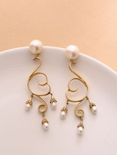 ♥ Dangling brass long earring ♥ Ethnic Pearl danglers in bohemian style, Tear drop pearls set in a curvy design. 18K Gold plated brass earrings. These danglers are super chic, versatile, light weight and hassle free. What makes it different in terms of design is the texture technique which is exclusively hand made. Grab these beauties !! WHY - YOU'LL - LOVE - IT * It's dainty and can be worn every day * A special piece you'll treasure * High-quality materials and attention to detail ~Made with L Bohemian Danglers For Wedding, Elegant Pearl Drop Hoop Earrings For Festive Occasions, Elegant Chandbali Hoop Earrings, Elegant Drop Clip-on Earrings With Latkans, Elegant Gold Hoop Earrings With Latkans, Yellow Gold Brass Danglers For Wedding, Elegant Metal Chandbali Chandelier Earrings, Elegant Chandbali Metal Chandelier Earrings, Wedding Yellow Gold Brass Danglers