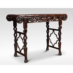 an old wooden table with carvings on the top and bottom, sitting against a white background