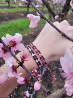 These lovely bracelets are inspired by the beautiful almond blossoms that bloom all over my hometown during the springtime. I've made the bracelet adjustable! Be careful when wearing around water, as friendship bracelets can curl up sometimes. Pink Bohemian Bracelets For Spring, Pink Friendship Bracelets For Spring, Resizable Bracelets For Spring, Spring Casual Hypoallergenic Jewelry, Casual Hypoallergenic Spring Jewelry, Casual Hypoallergenic Jewelry For Spring, Bohemian Beaded Bracelets For Friendship In Spring, Bohemian Beaded Bracelets For Friendship And Spring, Casual Spring Jewelry For Friendship