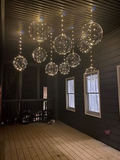 a room with lights hanging from the ceiling and windows on the side of the building