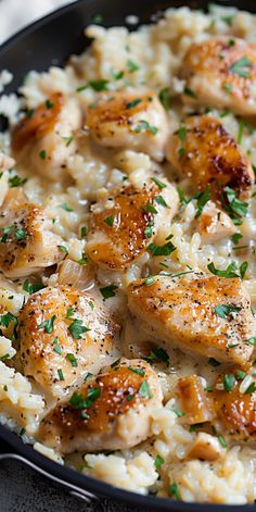 chicken and rice in a skillet with parsley on top