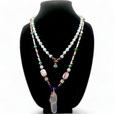 This exquisite necklace is a true masterpiece. The jade beads boast a deep green hue that exudes both a sense of tranquility and vitality. The pearls, on the other hand, are a gentle white that lends an air of sophistication. The quartz pendant is a clear crystal that glows like magic, reflecting light in a mesmerizing manner. The copper ornamentation, meanwhile, imparts a hint of refinement and warmth. This necklace is perfect for the woman who desires to feel confident and beautiful, and who wishes to make a statement. Whether you're dressing up for a special occasion or simply running errands, this necklace will infuse your ensemble with a touch of glamour. When you don this necklace, you'll feel like royalty. You'll feel empowered and beautiful, as if you could conquer anything. Elegant Jade Crystal Necklace With Round Beads, Elegant Jade Crystal Necklaces With Round Beads, Elegant Beaded Jade Crystal Necklaces, Elegant Beaded Jade Crystal Necklace, Handmade Elegant Amazonite Necklace, Elegant Amazonite Round Beads Jewelry, Elegant Gemstone Beads Necklaces For Layering, Elegant Round Beaded Amazonite Jewelry, Elegant Round Bead Amazonite Jewelry