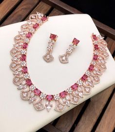 High quality 18kt Rose gold plated American diamond necklace studded with emerald cut color CZ stones. Luxury Diamond Kundan Necklace For Festive Occasions, Luxury Pink Bridal Necklace For Women, Green And Pink Jewellery Set, Luxury Pink Jewelry For Festive Occasions, Luxury Pink Jewelry Set For Celebration, Luxury Pink Jewelry Sets For Festive Occasions, Luxury Pink Temple Jewelry Necklaces, Rose Pink Necklace, Diamond Statement Necklace