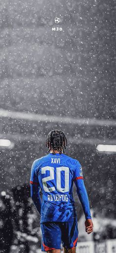 a soccer player is walking in the snow