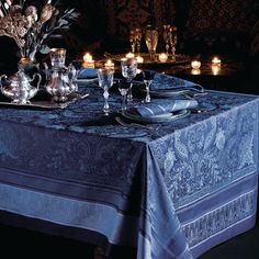 the table is set with silverware and candles