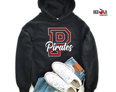 Personalized Pirates School Spirit T-Shirt Crewneck, Hoodie Hooded Sweatshirt Football, Baseball, Basketball, Softball, Track, Volleyball, Cross Country, Cheer, Wrestling Not all colors are available in all sizes and styles.  Please check the color and size charts in photos. We do our best to accurately represent shirt colors by using actual photos but do understand that all monitors will display differently. Please contact us prior to purchase with any questions on sizing or colors. Your purchase includes a custom imprint created specifically for your team! A product proof will be emailed to you within 1 business day.  Please keep an eye on your Etsy messages and reply with any changes within 24 hours. Your order will be sent to production after that time if no response is received. Exces School Shirt Ideas, Represent Shirt, Pirate Shirts, School Shirts, School Spirit, Cross Country, Shirt Ideas, Size Charts, Sweatshirt Hoodie