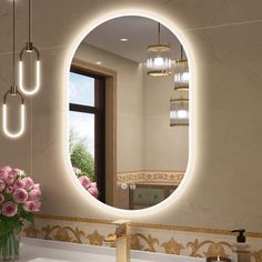 a bathroom sink with a mirror above it and flowers in the vase on the counter