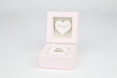 a pink ring box with a heart in it and the words say you on it